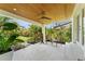 Inviting covered patio featuring tiled flooring and lush greenery, ideal for relaxation at 807 W Braddock St, Tampa, FL 33603