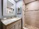 Updated bathroom featuring granite countertop, stylish vanity, and a tiled shower with river rock floor at 810 Island Walk Dr # 810, Tampa, FL 33602