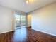 Bedroom featuring laminate wood flooring and sliding doors leading to patio at 810 Island Walk Dr # 810, Tampa, FL 33602