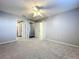 Carpeted bedroom with ceiling fan and two doors to the Primary bathroom and closet at 810 Island Walk Dr # 810, Tampa, FL 33602