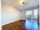 Bedroom featuring laminate wood flooring and sliding doors leading to patio at 810 Island Walk Dr # 810, Tampa, FL 33602