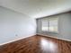 Bright bedroom featuring a window with plantation shutters and wood-look flooring at 810 Island Walk Dr # 810, Tampa, FL 33602