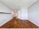 View of the bedroom showing wood-look flooring and a glimpse of an adjoining hallway at 810 Island Walk Dr # 810, Tampa, FL 33602