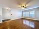 Bright living room with hardwood floors, plantation shutters, and a ceiling fan with a light at 810 Island Walk Dr # 810, Tampa, FL 33602