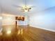 Open-concept living room featuring hardwood floors, modern lighting, and a view of the kitchen at 810 Island Walk Dr # 810, Tampa, FL 33602
