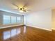 Spacious living room featuring hardwood floors, plantation shutters, and a ceiling fan at 810 Island Walk Dr # 810, Tampa, FL 33602