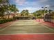 Well-maintained tennis court surrounded by lush greenery, perfect for recreation at 810 Island Walk Dr # 810, Tampa, FL 33602