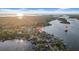 Beautiful aerial view of waterfront community homes and surrounding canals and waterways at sunset at 915 Bayshore Dr, Tarpon Springs, FL 34689