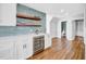 White and bright bar area featuring white cabinets, a cooler, and a tiled backsplash at 915 Bayshore Dr, Tarpon Springs, FL 34689