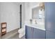 Modern bathroom with white tile shower, stylish blue vanity, and unique fixtures and finishes at 915 Bayshore Dr, Tarpon Springs, FL 34689
