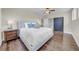 Comfortable bedroom with a ceiling fan, hardwood floors, and stylish decor, creating a serene and inviting atmosphere at 915 Bayshore Dr, Tarpon Springs, FL 34689