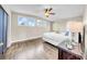 Bedroom with hardwood floors, a ceiling fan, three windows, and a nightstand creating a cozy and inviting atmosphere at 915 Bayshore Dr, Tarpon Springs, FL 34689