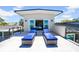 Modern deck featuring two lounge chairs overlooking the house and trees at 915 Bayshore Dr, Tarpon Springs, FL 34689