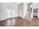 Bright and inviting entryway with wood floors, a modern staircase, and a view leading to the rest of the house at 915 Bayshore Dr, Tarpon Springs, FL 34689