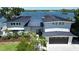 Beautiful modern home with lush landscaping and a view of the bay, showcasing its attractive curb appeal at 915 Bayshore Dr, Tarpon Springs, FL 34689
