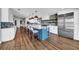 Open-concept kitchen featuring a blue island, quartz countertops, and stainless steel appliances at 915 Bayshore Dr, Tarpon Springs, FL 34689
