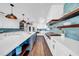 Bright kitchen with white cabinetry, stainless steel appliances, a blue tiled backsplash, and hardwood floors at 915 Bayshore Dr, Tarpon Springs, FL 34689