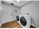 Laundry room with new washer and dryer, hardwood floors, and access door to the outdoors at 915 Bayshore Dr, Tarpon Springs, FL 34689