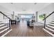 Spacious living room featuring a pool table, comfortable seating, and large windows showcasing waterfront views at 915 Bayshore Dr, Tarpon Springs, FL 34689