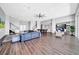 Spacious living area featuring wood floors, comfortable seating, and a connected kitchen for entertaining at 915 Bayshore Dr, Tarpon Springs, FL 34689