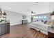 Bright main bedroom boasts wood floors, ceiling fan, wet bar, dresser, and sliding doors to the outside deck at 915 Bayshore Dr, Tarpon Springs, FL 34689
