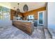 Outdoor kitchen with wood paneling, stainless steel appliances, and stone countertops at 915 Bayshore Dr, Tarpon Springs, FL 34689