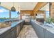 Stylish outdoor kitchen with stainless steel appliances, granite countertops, and a lovely waterfront view at 915 Bayshore Dr, Tarpon Springs, FL 34689