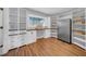 Spacious pantry featuring custom cabinets, wood countertops, stainless steel refrigerator, and wood grain flooring at 915 Bayshore Dr, Tarpon Springs, FL 34689