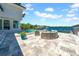 Expansive patio area overlooking waterfront featuring a pool, spa, and outdoor furniture for lounging at 915 Bayshore Dr, Tarpon Springs, FL 34689