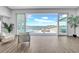 Stunning waterfront view through large sliding glass doors, showing the pool, dock, and outdoor living space at 915 Bayshore Dr, Tarpon Springs, FL 34689