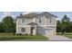 Charming two-story home with neutral siding, manicured lawn, and attached two-car garage at 10274 Gentle Rain Dr, Land O Lakes, FL 34638