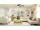 Bright living room with a ceiling fan, light walls, modern furniture, and stylish decor at 10274 Gentle Rain Dr, Land O Lakes, FL 34638