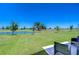 Beautiful backyard featuring manicured lawn, pond, and view at 10555 Penny Gale Loop, San Antonio, FL 33576