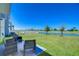 Relaxing backyard patio with seating and a serene view of the lake at 10555 Penny Gale Loop, San Antonio, FL 33576