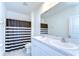 Bright bathroom featuring double sinks and showers with black and white curtains at 10555 Penny Gale Loop, San Antonio, FL 33576