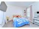 Bedroom featuring a bed, a desk, and a wall-mounted television at 10555 Penny Gale Loop, San Antonio, FL 33576