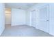 Neutral bedroom featuring gray carpeting and white doors at 10555 Penny Gale Loop, San Antonio, FL 33576