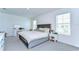 Bright bedroom featuring a tufted headboard bed, two windows, and a vanity at 10555 Penny Gale Loop, San Antonio, FL 33576