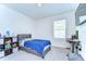 Bedroom featuring a bed, a desk, and a wall-mounted television at 10555 Penny Gale Loop, San Antonio, FL 33576