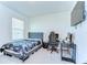 Bedroom featuring a bed, a desk, and a wall-mounted television at 10555 Penny Gale Loop, San Antonio, FL 33576