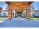 Grand entrance of the community center with stone pillars, wood accents, and lush landscaping at 10555 Penny Gale Loop, San Antonio, FL 33576