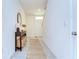 Bright home entryway featuring tiled floors, a console table, and a decorative rug at 10555 Penny Gale Loop, San Antonio, FL 33576