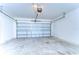 A spacious, unfinished two car garage with concrete floors at 10555 Penny Gale Loop, San Antonio, FL 33576