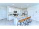 Modern kitchen with white cabinets, granite countertops, an island with seating, and stainless steel appliances at 10555 Penny Gale Loop, San Antonio, FL 33576