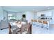 Open-concept living space featuring modern furniture, a dining area, and a stylish kitchen with a kitchen island at 10555 Penny Gale Loop, San Antonio, FL 33576