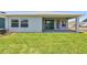 Lush backyard featuring green grass, covered patio, and serene outdoor space at 11834 Mile Marsh Dr, Riverview, FL 33569