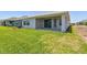 Expansive backyard with lush green grass, a covered patio, and a serene outdoor space at 11834 Mile Marsh Dr, Riverview, FL 33569