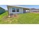 Large backyard with green grass, a covered patio, and a relaxing outdoor area at 11834 Mile Marsh Dr, Riverview, FL 33569