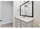 Well-lit bathroom with shaker cabinets, a quartz countertop, gold hardware, and modern fixtures at 11834 Mile Marsh Dr, Riverview, FL 33569