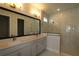 Luxurious bathroom featuring double vanity, large mirror, and glass-enclosed walk-in shower with marble tiling at 11834 Mile Marsh Dr, Riverview, FL 33569
